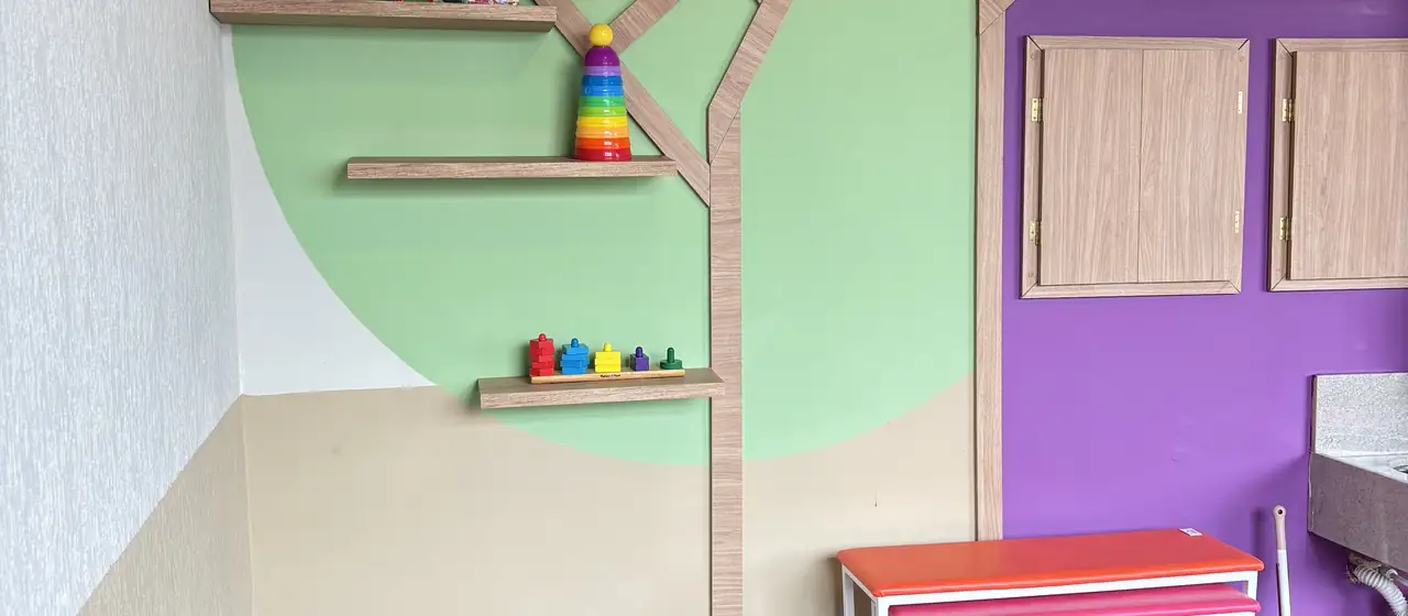 Sala de atendimento com casinha lilás e brinquedos